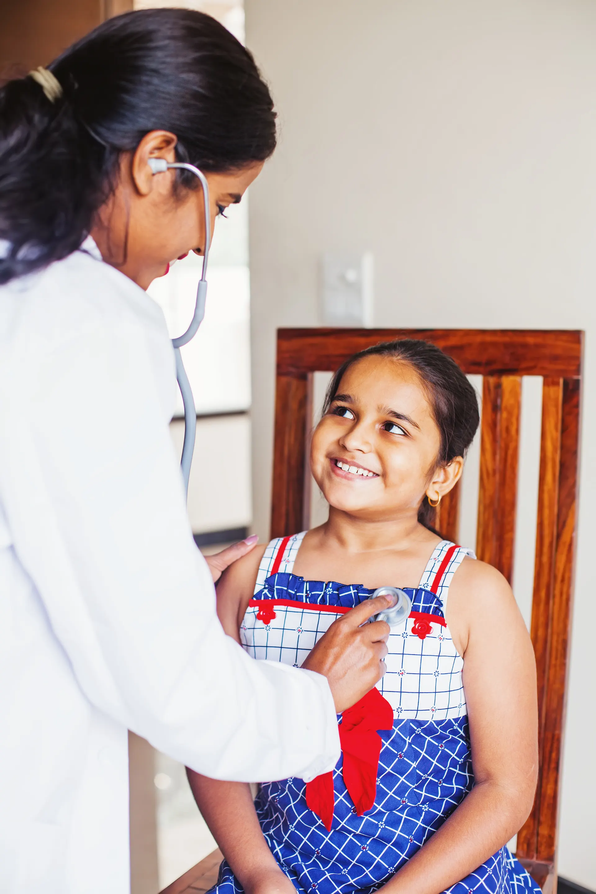 Doctor examining a young patient with a stethoscope at PingMeDoc clinic